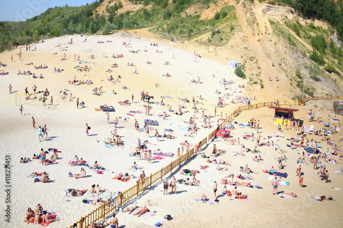 Many people sunbathe on the sandy beach of the Lyubertsy career