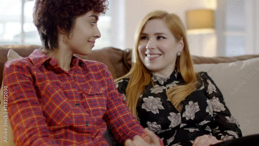Affectionate gay female couple relaxing together at home Affectionate gay female couple relaxing together at home