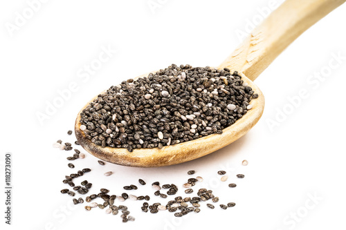 Chia seeds on a wooden spoon seen from the front on white background