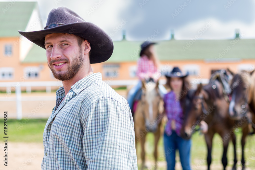 cowboy closeup portrait on background of horses cowboy closeup portrait on background of horses