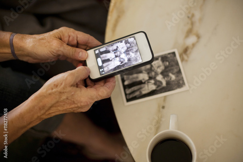 Caucasian woman taking cell phone picture of photograph photo