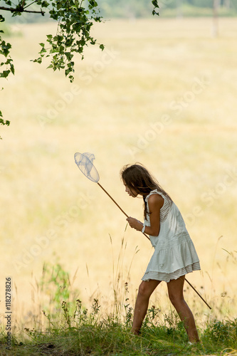 girl with butterfly net and a white dress