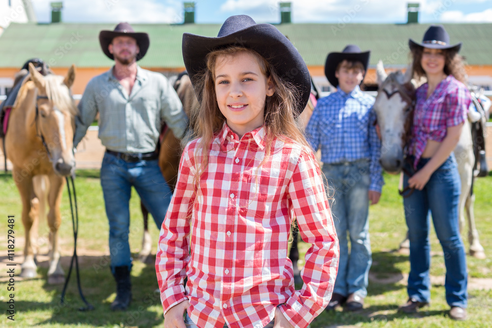 cowboy girl closeup portrait on background of her family cowboy girl closeup portrait on background of her family