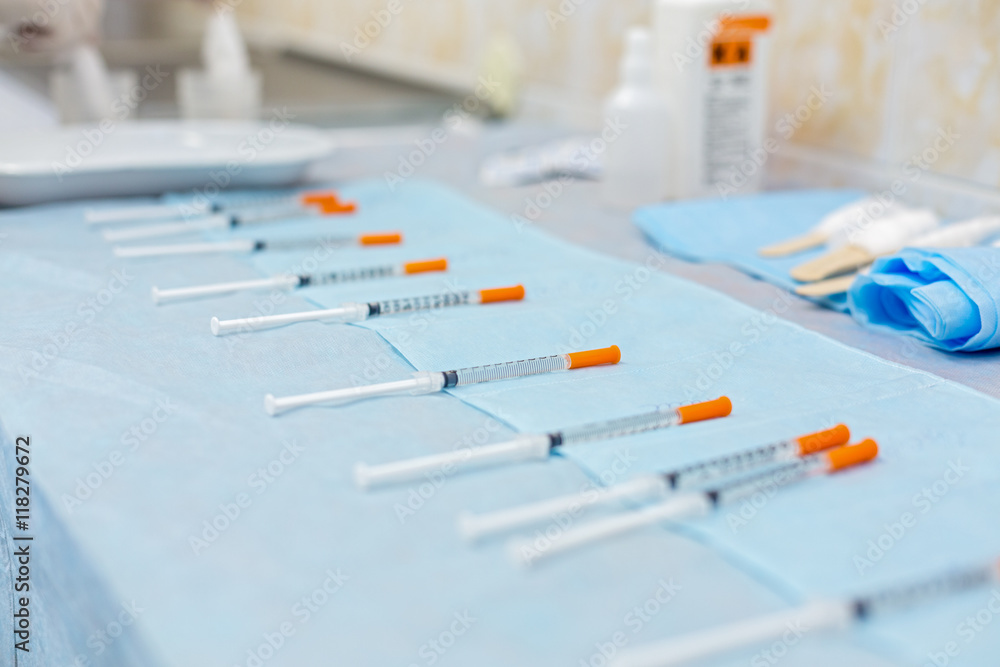 row of syringes with medicines