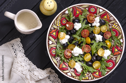 Arugula salad with cherry tomatoes feta and olives  