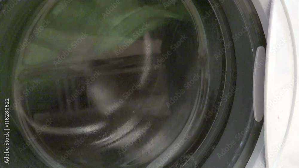 Washing machine washes laundry background closeup Washing machine washes laundry background closeup