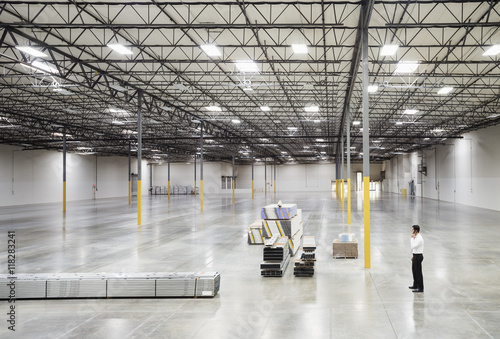 Caucasian businessman standing in empty warehouse photo