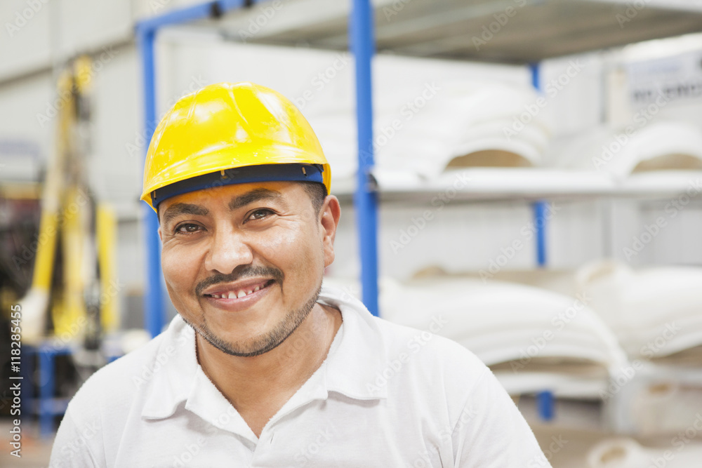 Worker smiling in manufacturing plant Worker smiling in manufacturing plant