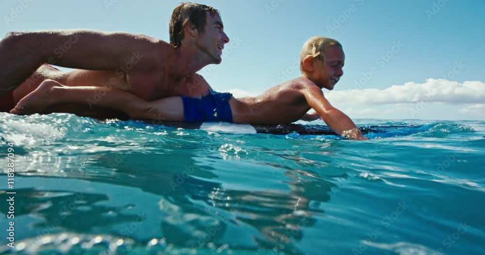 Father and son having fun surfing together, summer lifestyle family time