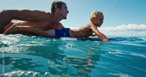 Father and son having fun surfing together, summer lifestyle family time