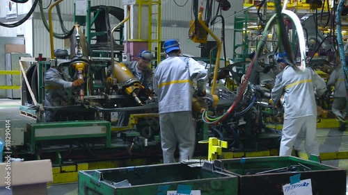 Car Production. Car Production. Four Male Factory Workers With Large Welding Machines Product Car Body