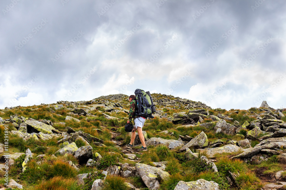 Tourist climb up the stone trail to the mountain top, Carpathians, Ukraine.