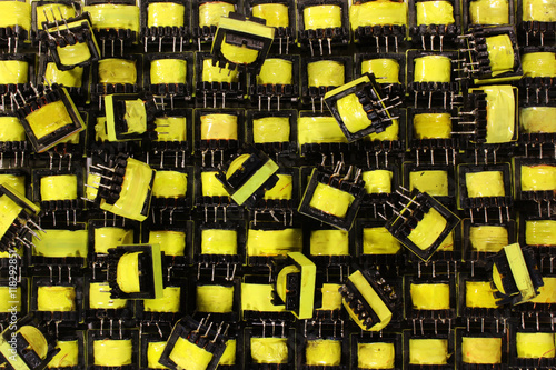 Schilderij op canvas Many small yellow electrical ferrite transformers