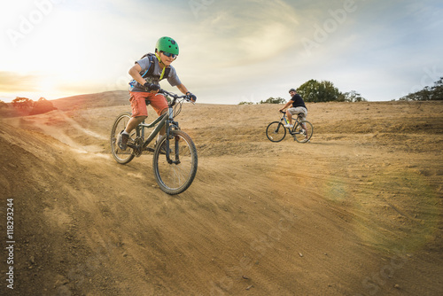 Boy riding dirt bikes on track photo