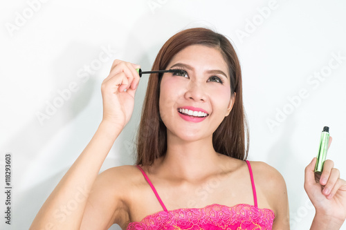 Makeup woman putting mascara eye make up on eyes. Asian fresh fa