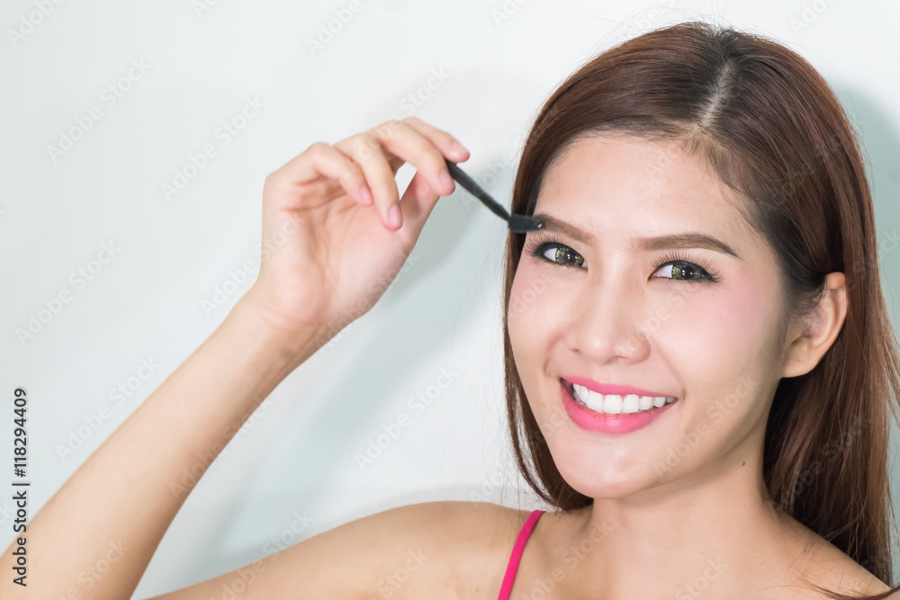 © Manintino - Closeup beautiful woman with eyebrow brush © Manintino - Closeup beautiful woman with eyebrow brush