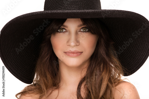 Portrait of young woman in hat.