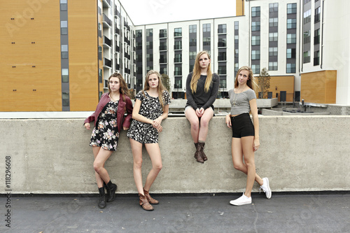 Teenage girls posing on urban rooftop photo