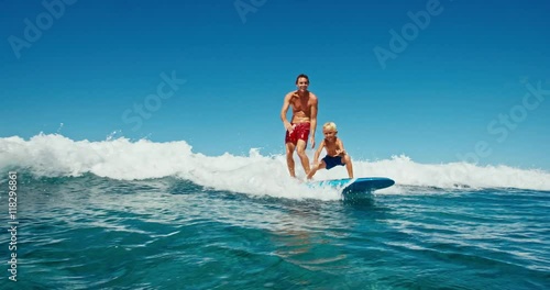 Father and son having fun surfing together, summer lifestyle family time