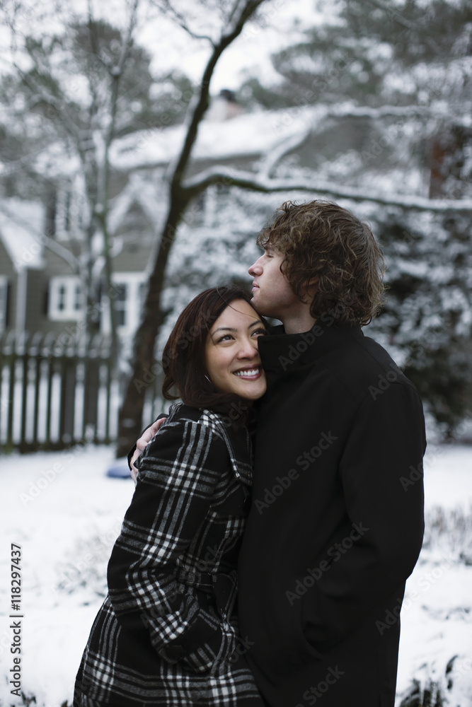 Couple hugging outdoors in snow Couple hugging outdoors in snow
