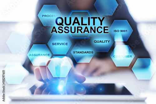 Quadro em tela Woman using tablet pc and pressing Quality assurance on virtual screen