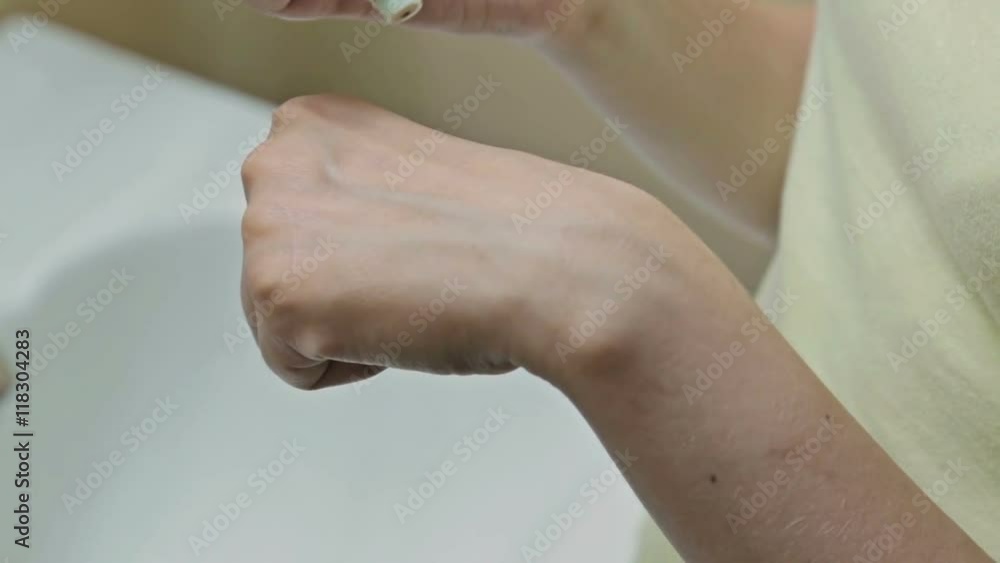 Woman squeezing out the foundation on her hand and takes it with a sponge, close up shot. Beauty and makeup concept Woman squeezing out the foundation on her hand and takes it with a sponge, close up shot. Beauty and makeup concept