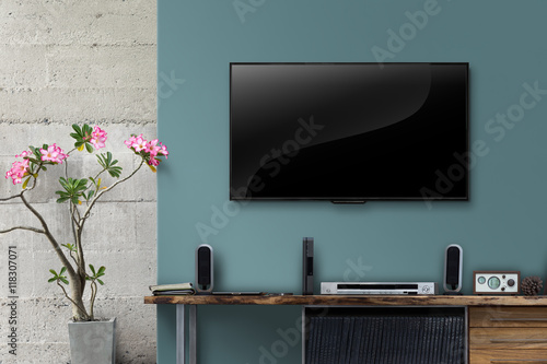 Led tv on color concrete wall with wooden table in living room