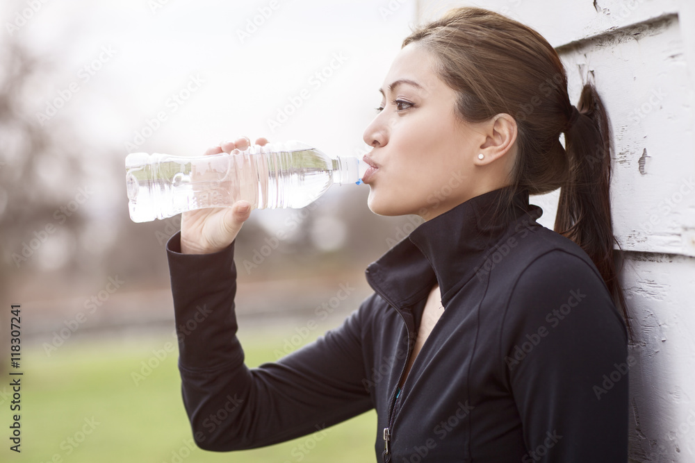 Woman drinking water from bottle Woman drinking water from bottle