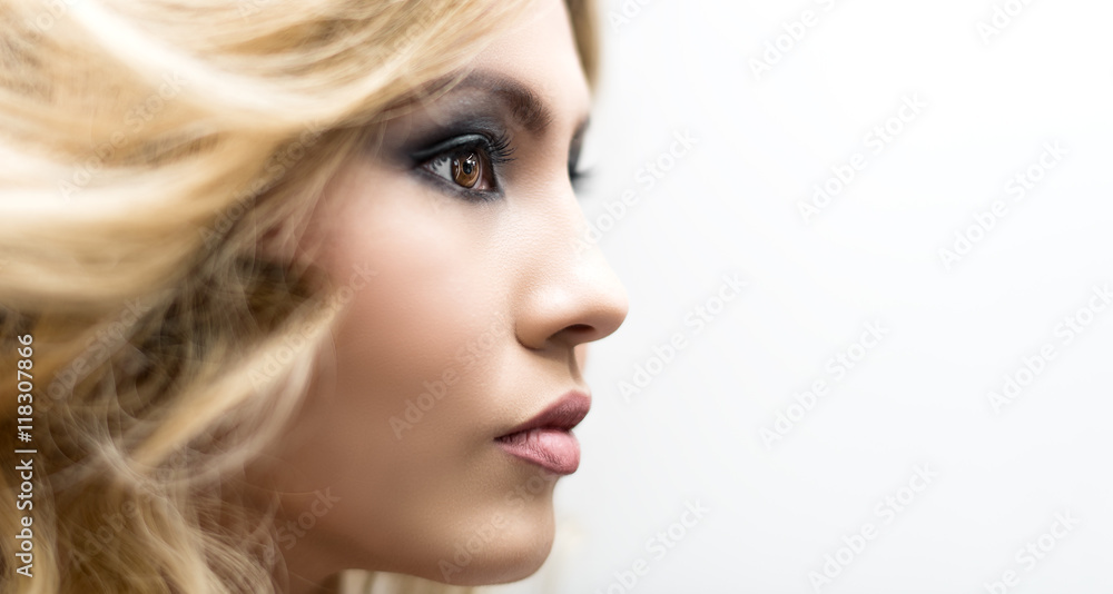 Obraz premium Close up brown eye with makeup looking at the side, macro shot with perfect skin