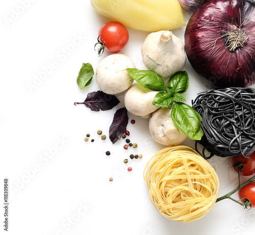 white and black pasta and fresh basil, mushrooms, cherry tomatoes, onions, peppers on a white background