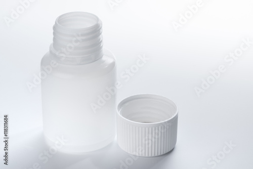 White plastic medical container bottle, on gray background