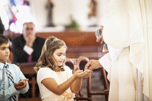 Girl taking her first communion at church