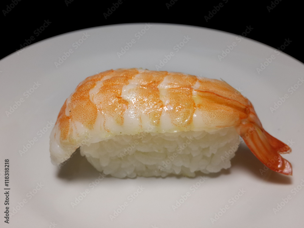 Shrimp and sushi on the white dish Shrimp and sushi on the white dish