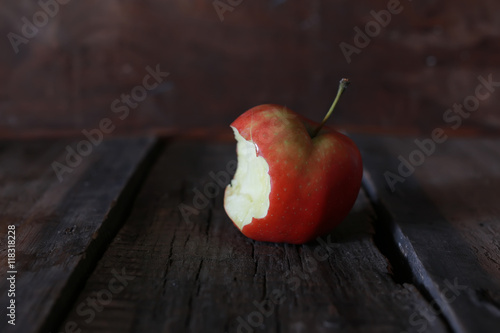 bitten apple on a wooden background