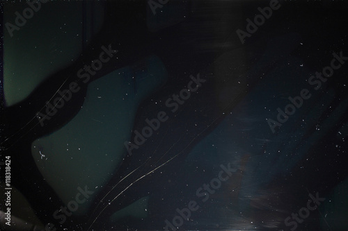 Old dusty black digital screen with cracks. Broken screen of smartphone, tablet, laptop, tv-set monitor close-up. Damaged device background