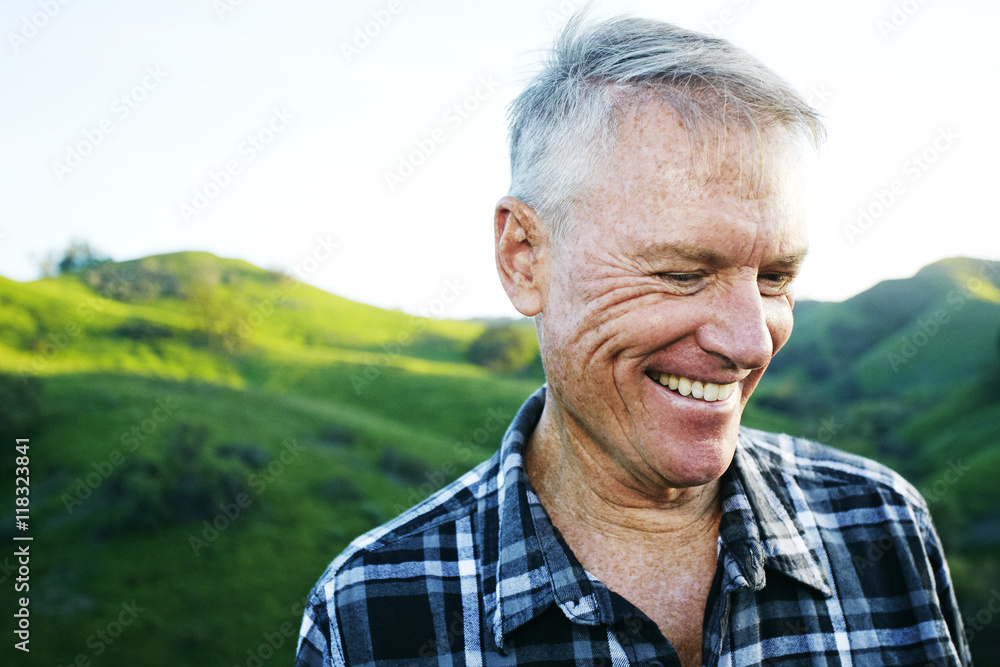 Older Caucasian man smiling on rural hilltop Older Caucasian man smiling on rural hilltop