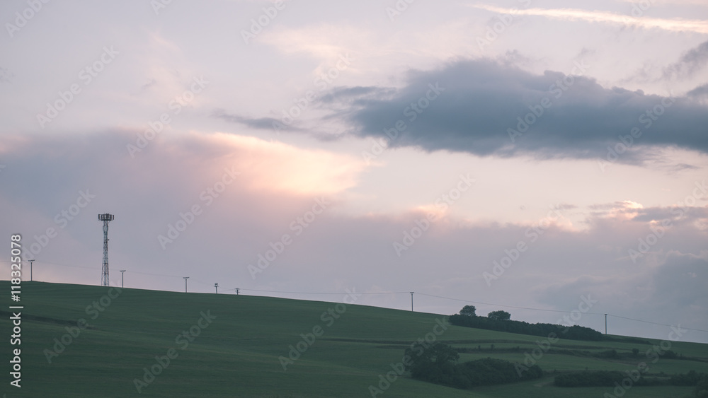 Dark storm clouds over meadow with green grass - vintage effect Dark storm clouds over meadow with green grass - vintage effect