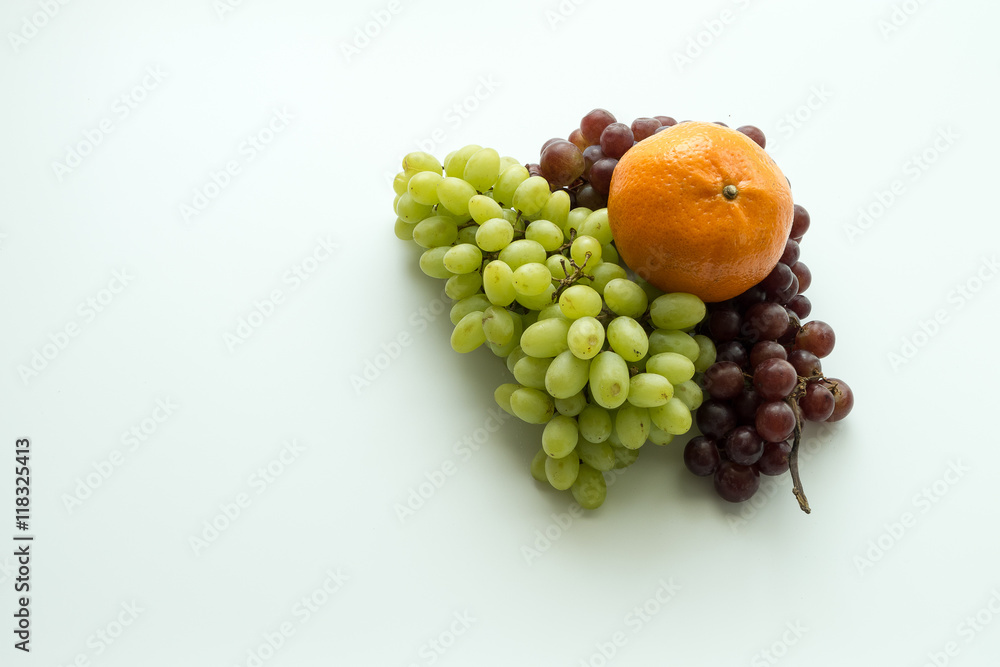 Oranges and grapes on white background