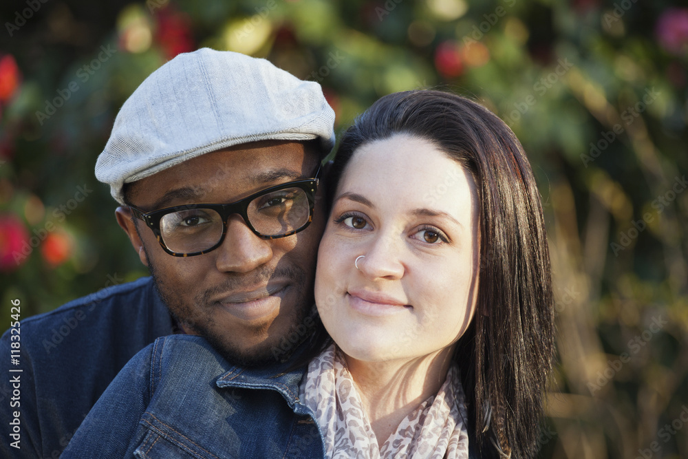 Smiling couple standing outdoors Smiling couple standing outdoors