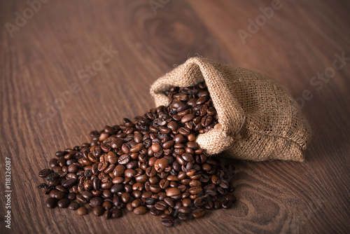 Coffee beans on wooden background © SasaStock