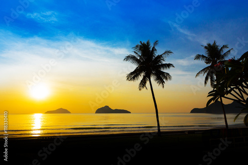 Fototapeta Naklejka Na Ścianę i Meble -  Sunrise at sea with islands and coconut trees.