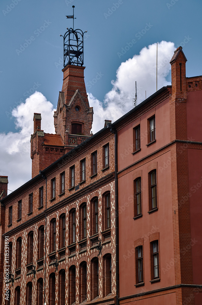 The facade of red brick building in Poznan.