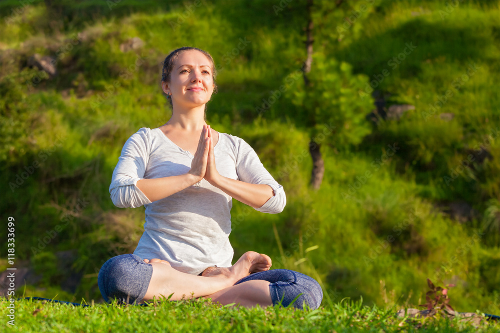 Young sporty fit woman doing yoga Lotus pose oudoors Young sporty fit woman doing yoga Lotus pose oudoors