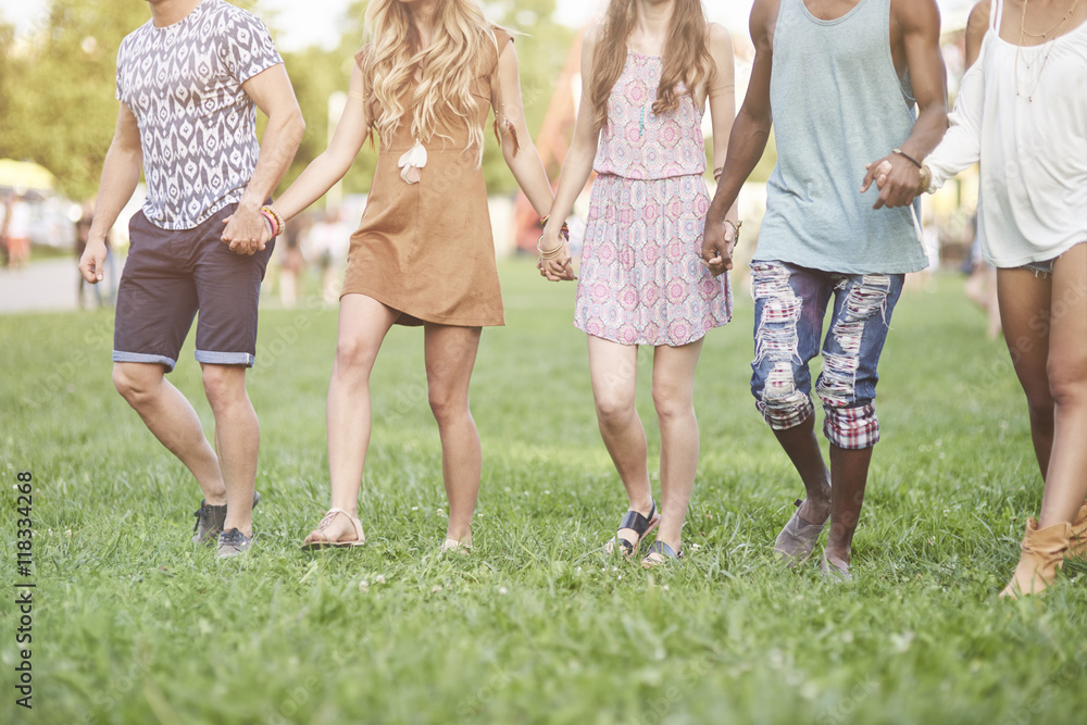 Fototapeta premium Friends walking hand by hand
