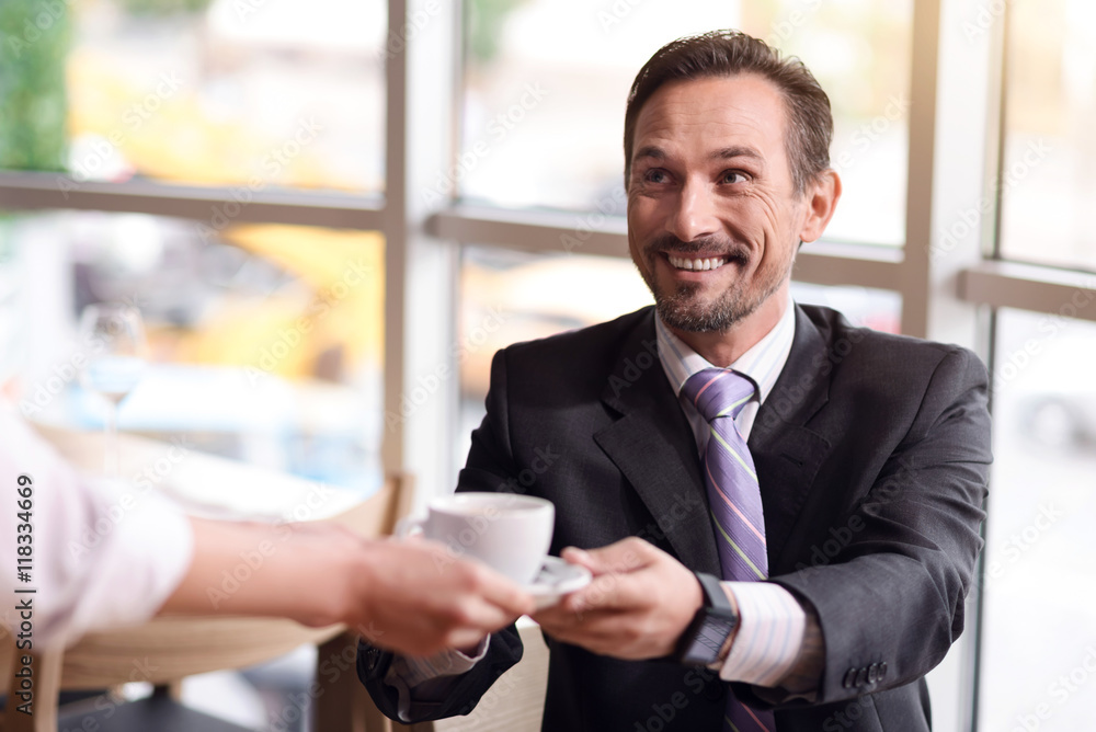 Cheerful businessman resting in the cafe Cheerful businessman resting in the cafe