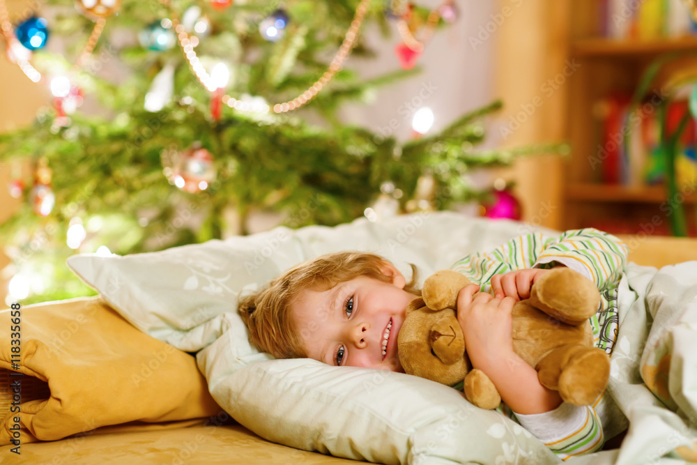 Little cute blond child sleeping under Christmas tree Little cute blond child sleeping under Christmas tree