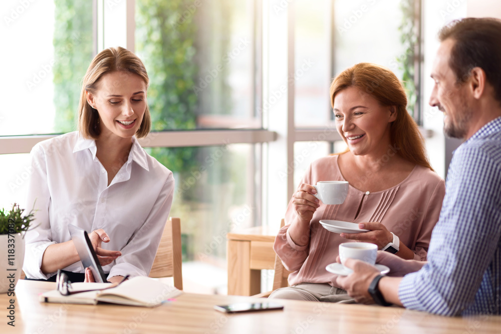 Delighted smiling colleagues drinking coffee Delighted smiling colleagues drinking coffee