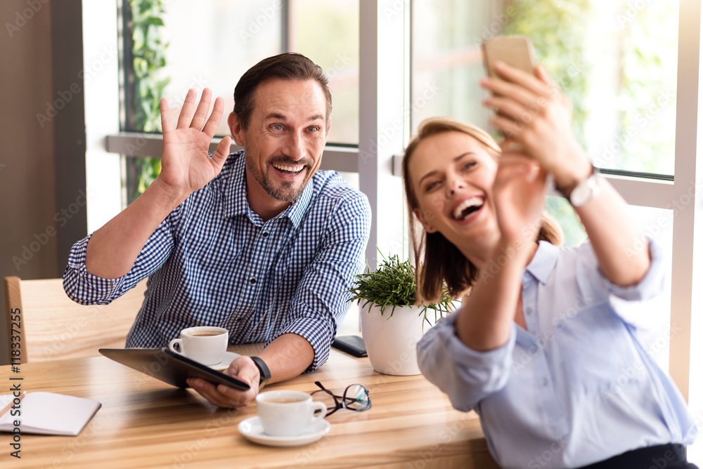 Fototapeta premium Cheerful colleagues making selfies