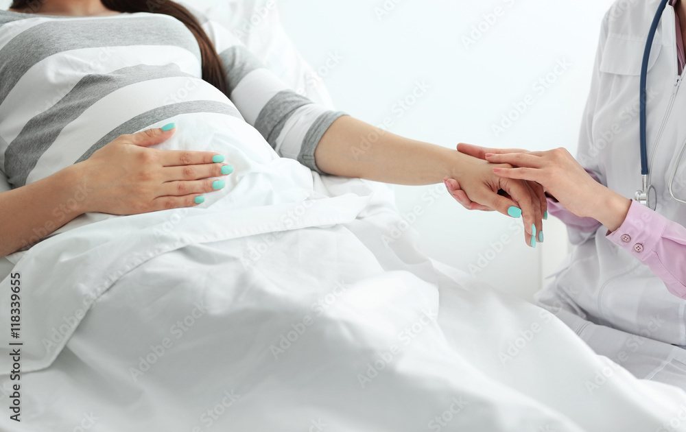Young pregnant woman with doctor at the hospital Young pregnant woman with doctor at the hospital