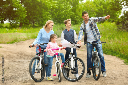 Happy family with map on bike ride